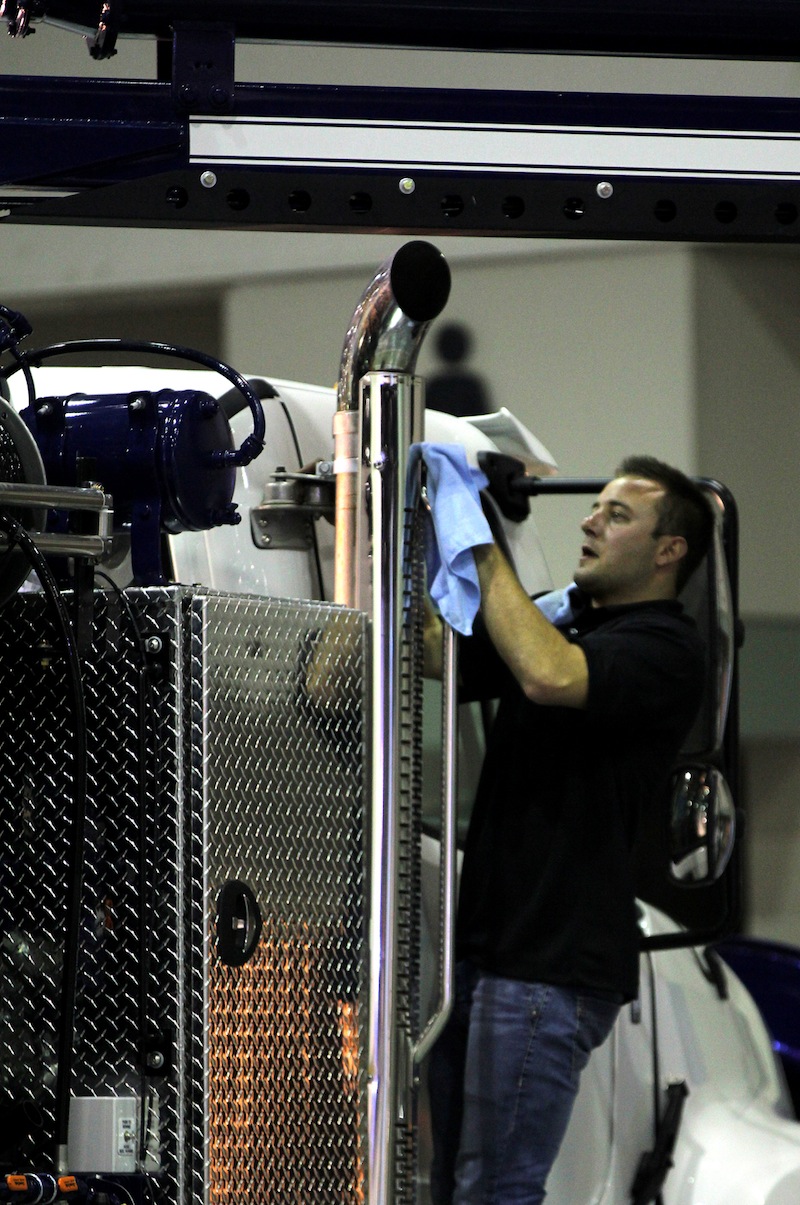 A cleaning crew works on polishing a combo vac truck during the WWETT Show setup on Tuesday.